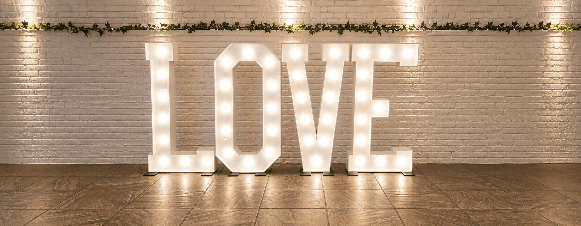 Illuminated LOVE sign at a wedding venue