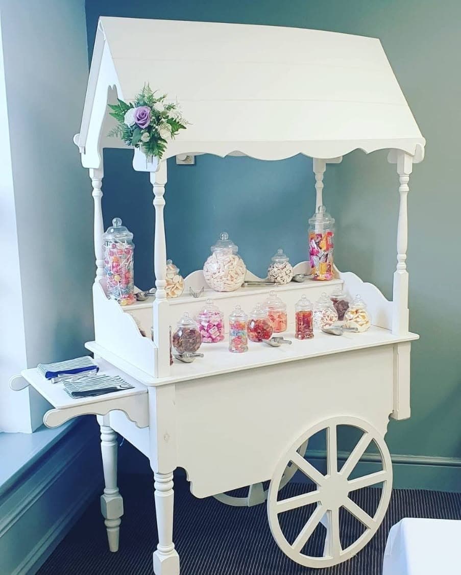 White candy cart setup for a children's party