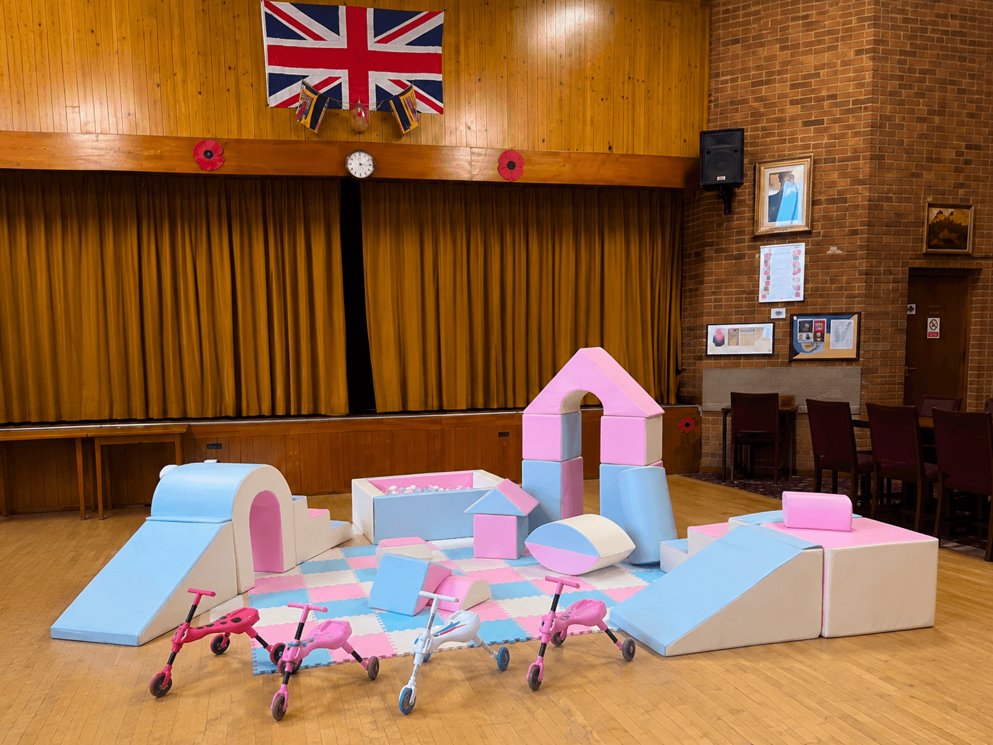 Pastel soft play setup with ball pit and ride-ons from Cameron's Events
