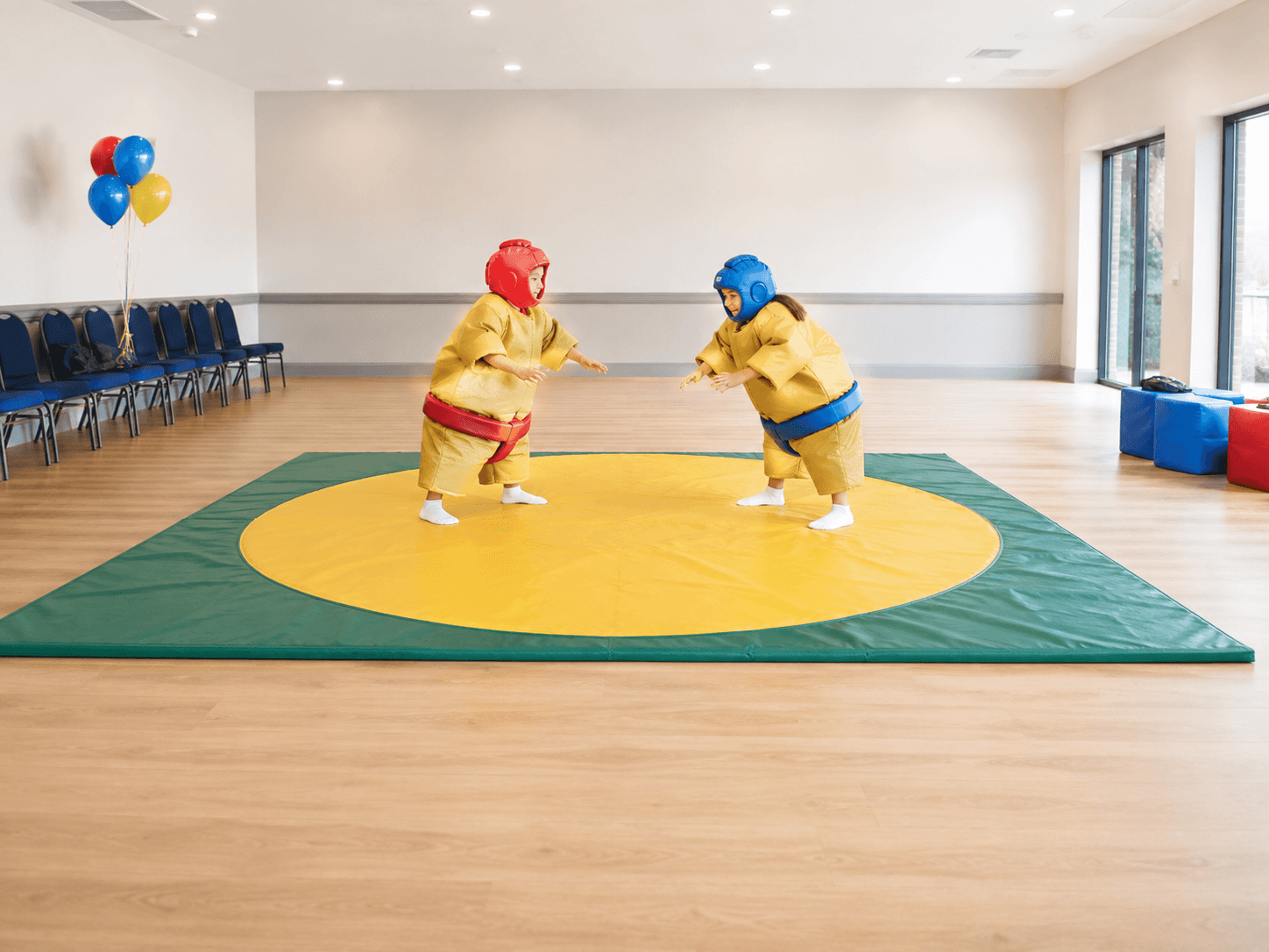 Clear indoor sumo activity area with padded mat and open surrounding space