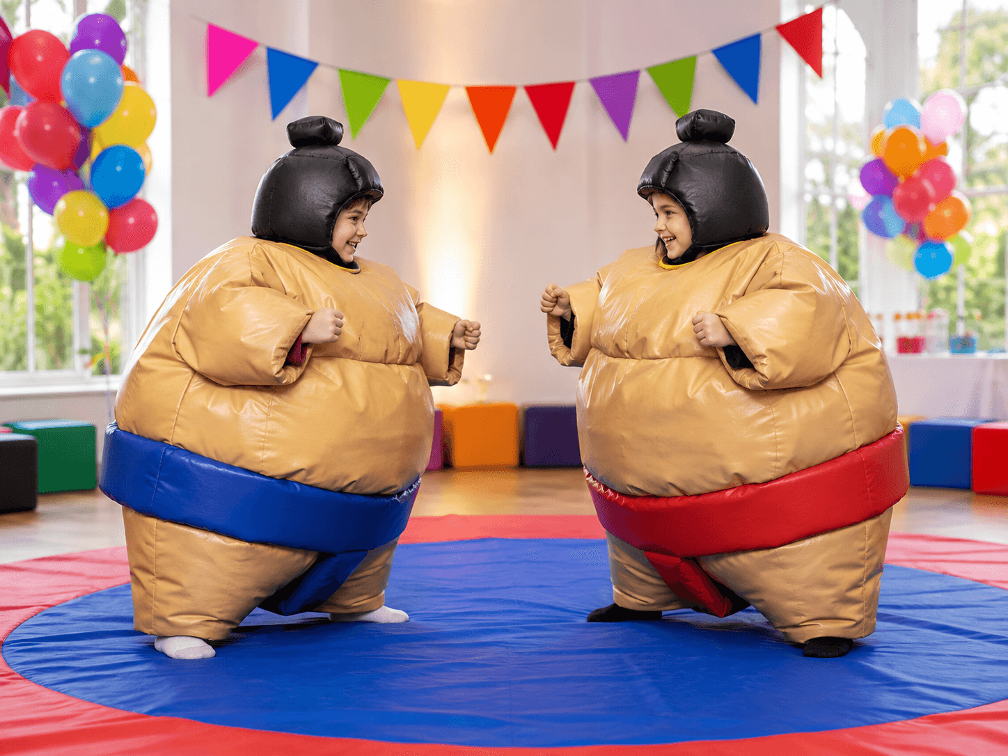 Two participants wearing padded sumo suits at a party