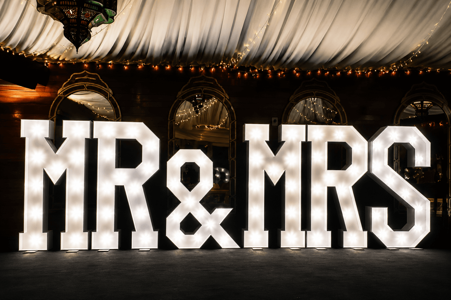 Illuminated LED Mr and Mrs sign at an elegant wedding reception from Cameron's Events